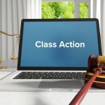 Class Action – Law, Judgment, Web. Laptop in the office with t